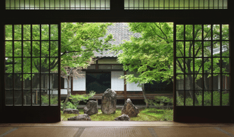 Ein traditioneller japanischer Garten mit sorgfältig platzierten Steinen, einem kleinen Teich und grünen Pflanzen, die eine ruhige Atmosphäre schaffen.